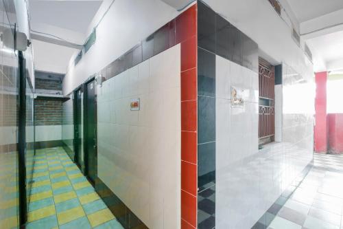 an empty hallway with colorful tiles on the wall at SPOT ON Hotel Amantran in Bhāgalpur