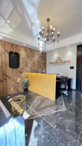 a lobby with a table and a chandelier at Hotel Golden Suites - Near Nesco in Mumbai