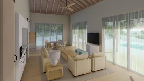 sala de estar con caja de cartón y TV en Ambergris Cay Private Island All Inclusive - Island Hopper Flight Included en Big Ambergris Cay