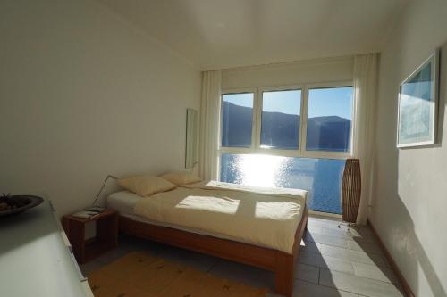 a bedroom with a bed and a large window at Villa Acapulco App 4044 in Moscia