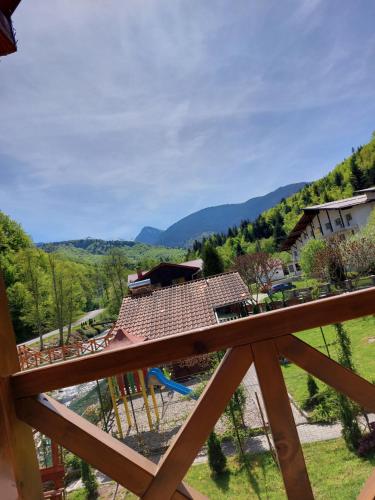 a view of a playground with a house at Dor de Munte Transfăgarasan in Cîrţişoara