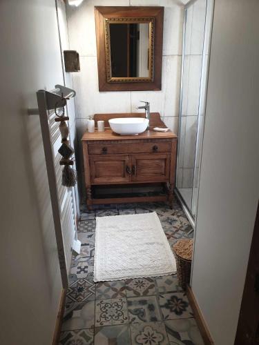 une salle de bain avec un lavabo et un miroir dans l'établissement Miller house in a water mill from the 12th century, à Négreville