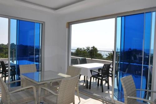 a dining room with a table and chairs on a balcony at Beachway Hotel Side in Side