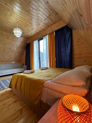 a bedroom with two beds in a wooden room at Royal Cottages in Kazbegi