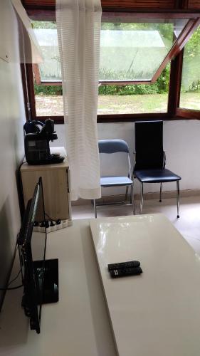 a room with two chairs and a table with a remote control at Magnifique Studio du Chateau VLP in Vaux-le-Pénil