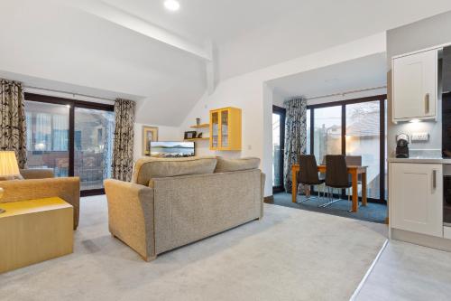 a living room with a couch and a table at Hapimag Burnside Park Apartments in Bowness-on-Windermere