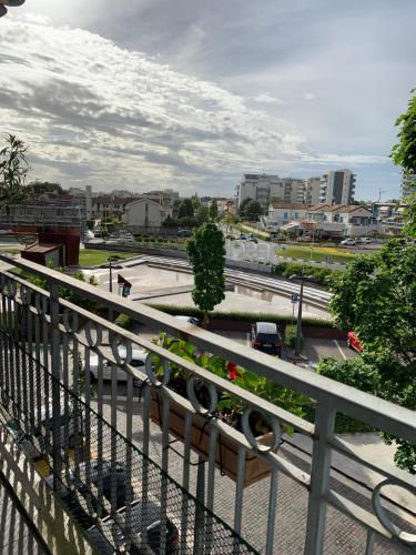 a balcony with a bench with flowers on it at Appartamento Jesolo Piazza Drago in Lido di Jesolo