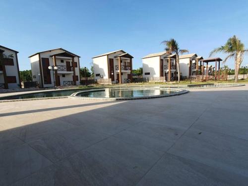 a building with a pool in the middle of a street at Casa Icaria Atins MA in Atins