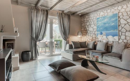 a living room with a couch and a table at Tyros Boutique Houses Villas in Tyros