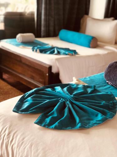 two beds with blue dresses on top of them at Awesome Place in Ella