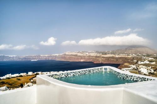 a swimming pool with a view of the ocean at 360o 2BD Panoramic Apartment in Akrotiri