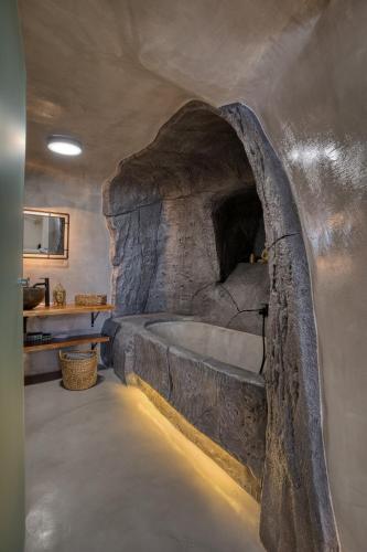 a bathroom with a large stone tub in a room at 360o 2BD Panoramic Apartment in Akrotiri