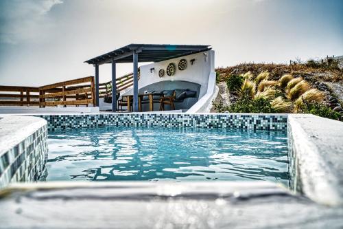 a swimming pool with a boat in the water at 360o 2BD Panoramic Apartment in Akrotiri