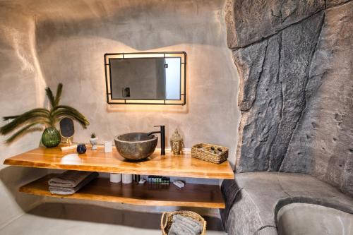 a bathroom with a sink and a mirror on a wall at 360o 2BD Panoramic Apartment in Akrotiri