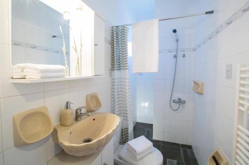a white bathroom with a sink and a toilet at Casa Hara2 in Lefkada Town