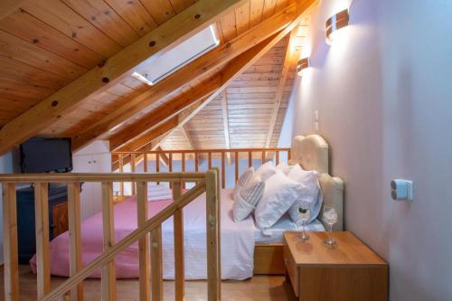 a attic bedroom with a bed and a staircase at Casa Hara2 in Lefkada Town