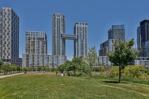 a park in front of a city with tall buildings at GLOBALSTAY New Fabulous Toronto Condo in Toronto