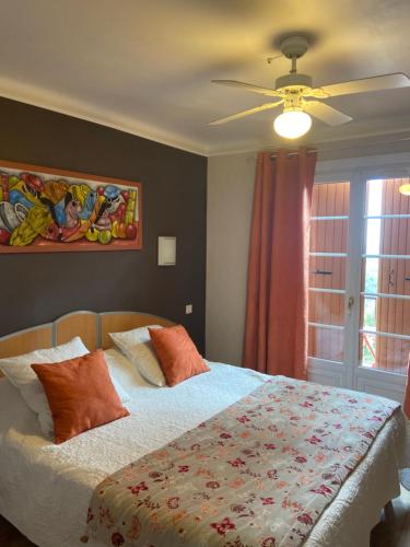 a bedroom with a bed and a ceiling fan at Les Belles Terrasses in Tourrettes-sur-Loup