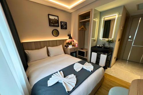 a bedroom with a bed with bows on it at Woxx Hotel in Istanbul