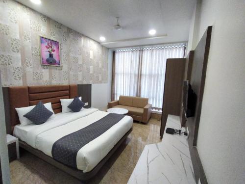 a bedroom with a bed and a television in it at Hotel Lee Pride in Anand
