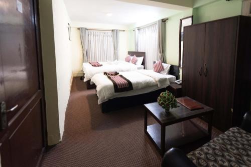 Postel nebo postele na pokoji v ubytování Yeti Cozy Hotel
