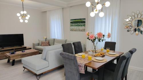 a living room with a dining table and a couch at Linos House in Avliótai