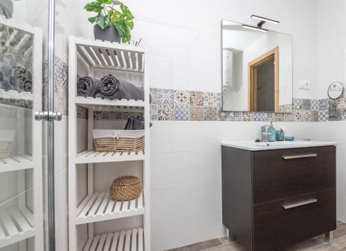 a bathroom with a sink and a mirror at Palm Beach Fuerteventura in Tarajalejo