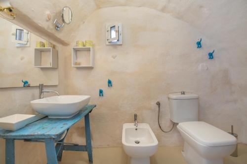 a bathroom with a sink and a toilet at Tenuta Miro in Ostuni