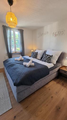 1 cama grande en un dormitorio con manta azul en Ferienhaus Bühlertal mit 3 Fewos, en Bühlertal