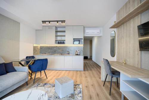 a kitchen and living room with a couch and a table at AboutArtApartments - Otyńska 4 in Wrocław