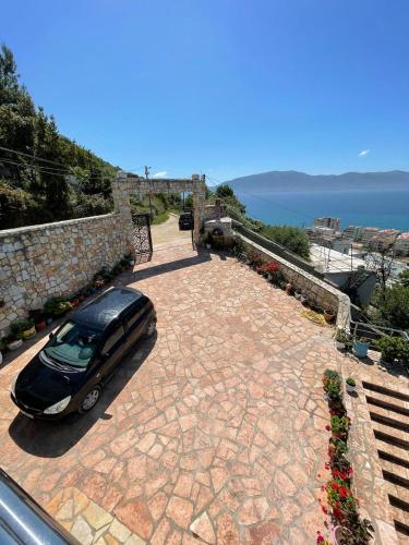 a car parked on top of a stone driveway at Panorama Sea View Apartments in Vlorë
