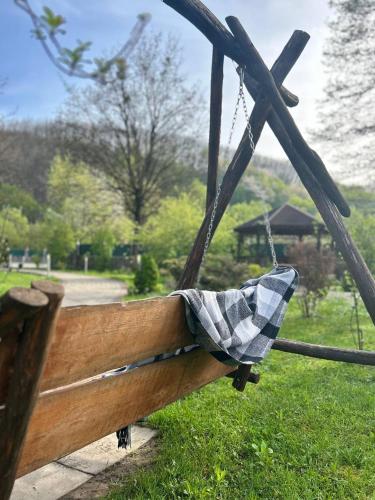 a wooden bench with a checkered cloth on it at VitaPark Poliana in Polyana
