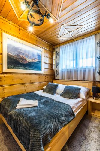 a bedroom with two beds in a wooden cabin at Apartament Regionalny Centrum in Zakopane