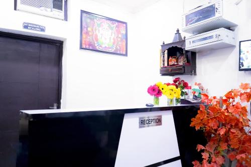 a room with a counter with flowers on it at Hotel In Jangpura Bhogal in New Delhi