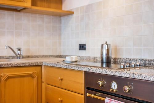 a kitchen with a sink and a stove at Apartments Mirabell in Livinallongo del Col di Lana