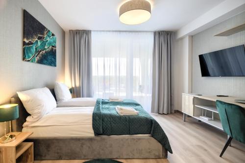 a hotel room with a bed and a tv at AboutArtApartments - Otyńska 4 in Wrocław