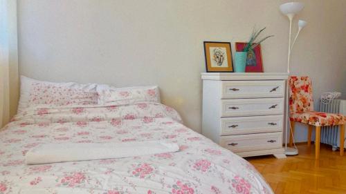 a bedroom with a bed and a dresser at Mint Apartment in Tivat