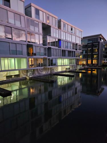 a group of buildings next to a body of water at Pavilions Marina Apartment 102 - Wynyard Quarter Viaduct Harbour in Auckland