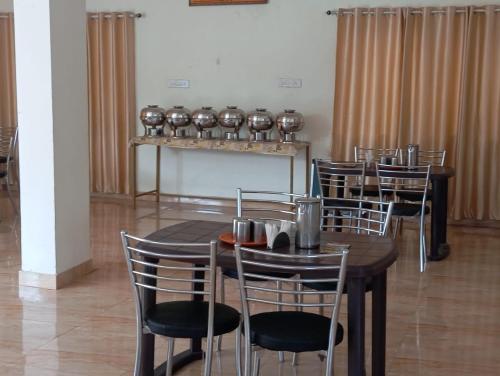 a dining room with tables and chairs and a fireplace at Blue Bell Homestay in Lonavala