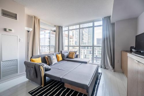 a living room with a couch and a large window at GLOBALSTAY New Fabulous Toronto Condo in Toronto