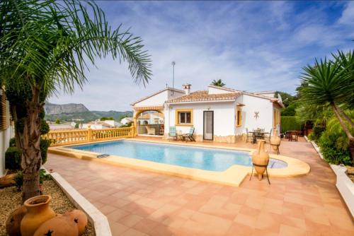 a villa with a swimming pool and a house at Villa El Huerto in Orba