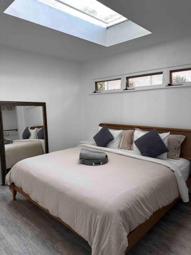 a bedroom with a large bed with a skylight at 30 PCT OFF!! Limited Time! Malibu Ocean Wave with King Bed, Walking to Beach and Hiking in Malibu