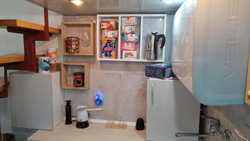 a kitchen with white cabinets and a refrigerator at Nitro Inn 1 Premium Cozy - Wine Tasting - Souvenir - Art Gallery - Private Guided Tours - Relaxing - Romantic in Skopje