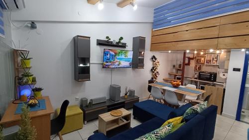 a living room with blue couches and a tv at Nitro Inn 1 Premium Cozy - Wine Tasting - Souvenir - Art Gallery - Private Guided Tours - Relaxing - Romantic in Skopje