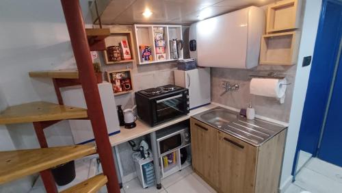 a small kitchen with a stove and a sink at Nitro Inn 1 Premium Cozy - Wine Tasting - Souvenir - Art Gallery - Private Guided Tours - Relaxing - Romantic in Skopje