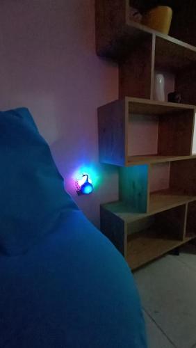 a room with a bed with a light next to a shelf at Nitro Inn 1 Premium Cozy - Wine Tasting - Souvenir - Art Gallery - Private Guided Tours - Relaxing - Romantic in Skopje