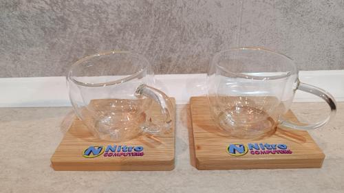 two glass mugs sitting on top of wooden blocks at Nitro Inn 1 Premium Cozy - Wine Tasting - Souvenir - Art Gallery - Private Guided Tours - Relaxing - Romantic in Skopje