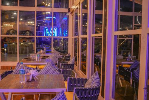 a restaurant with tables and chairs and a sign that says max at Urban Monk Stays and Cafe in Manāli