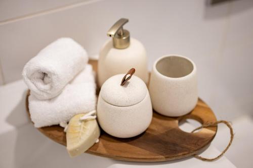 a wooden tray with towels and toiletries on it at Isrentals Haneviim - ApartHotel In City Center in Jerusalem