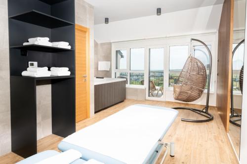 a bathroom with a tub and a hammock in a room at Fruške Residences in Vrdnik